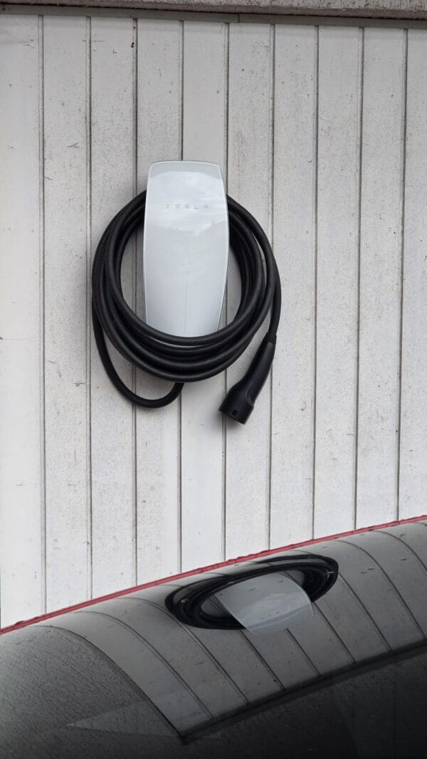 Polnilnica Tesla Wall Connector v garaži z električnim vozilom